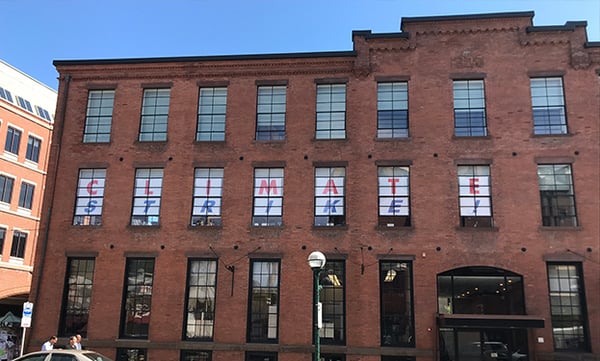 60-foot Climate Strike sign in our windows.